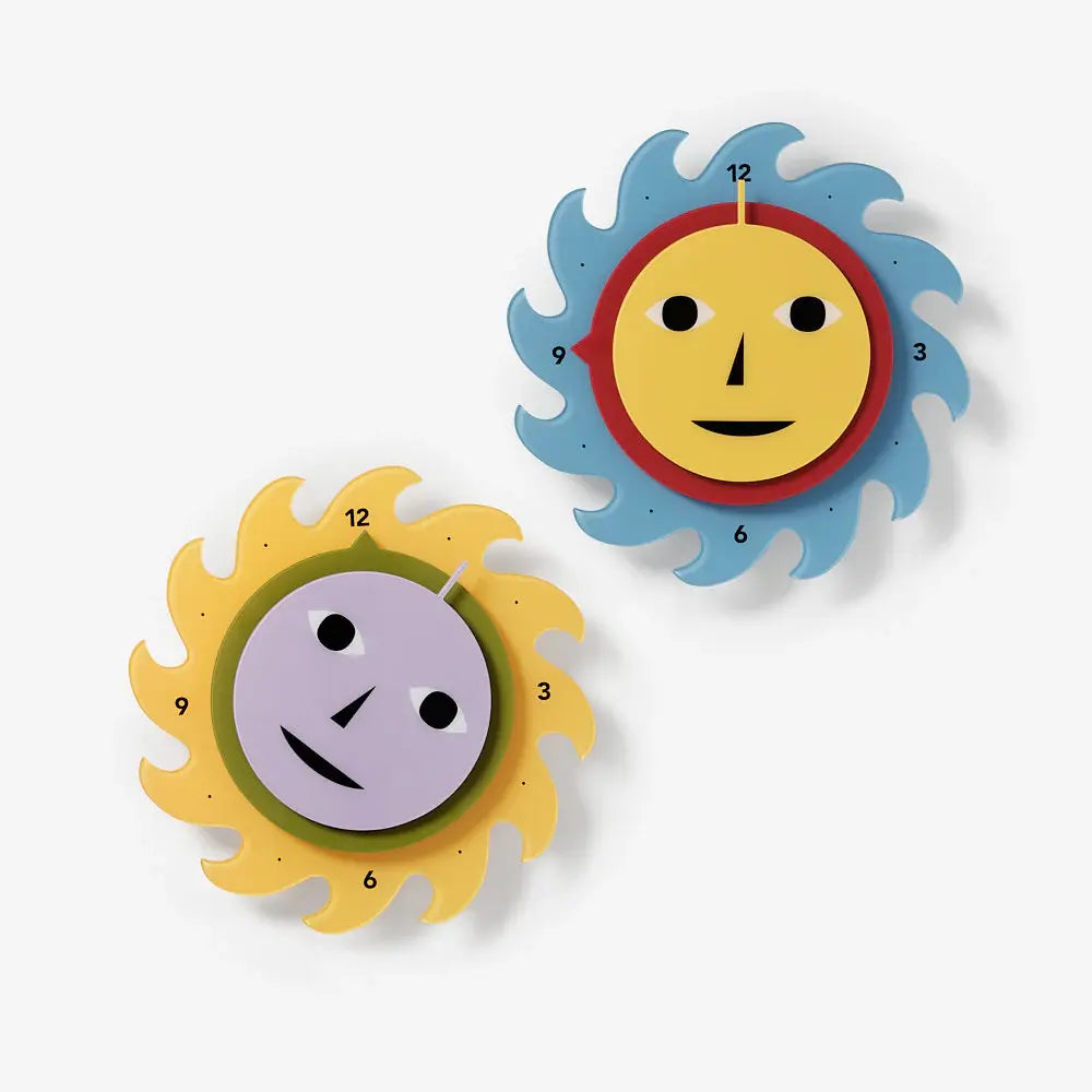 Two colorful wall clocks with sun designs on a white background