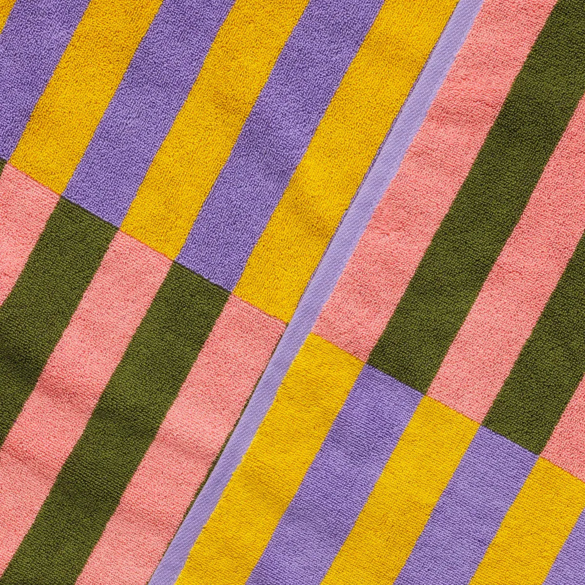 Colorful striped towel with pink, yellow, green, and purple stripes.
