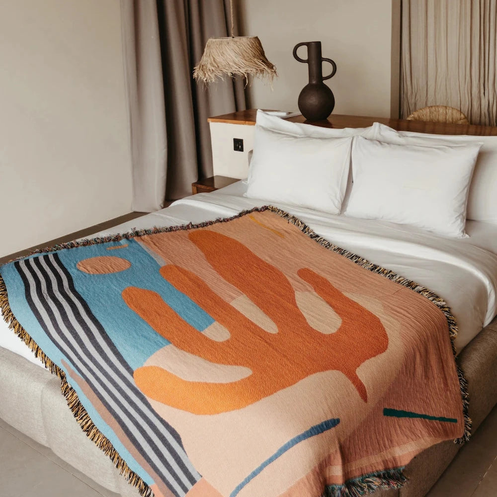 Orange and blue throw bed blanket with abstract cactus plant design
