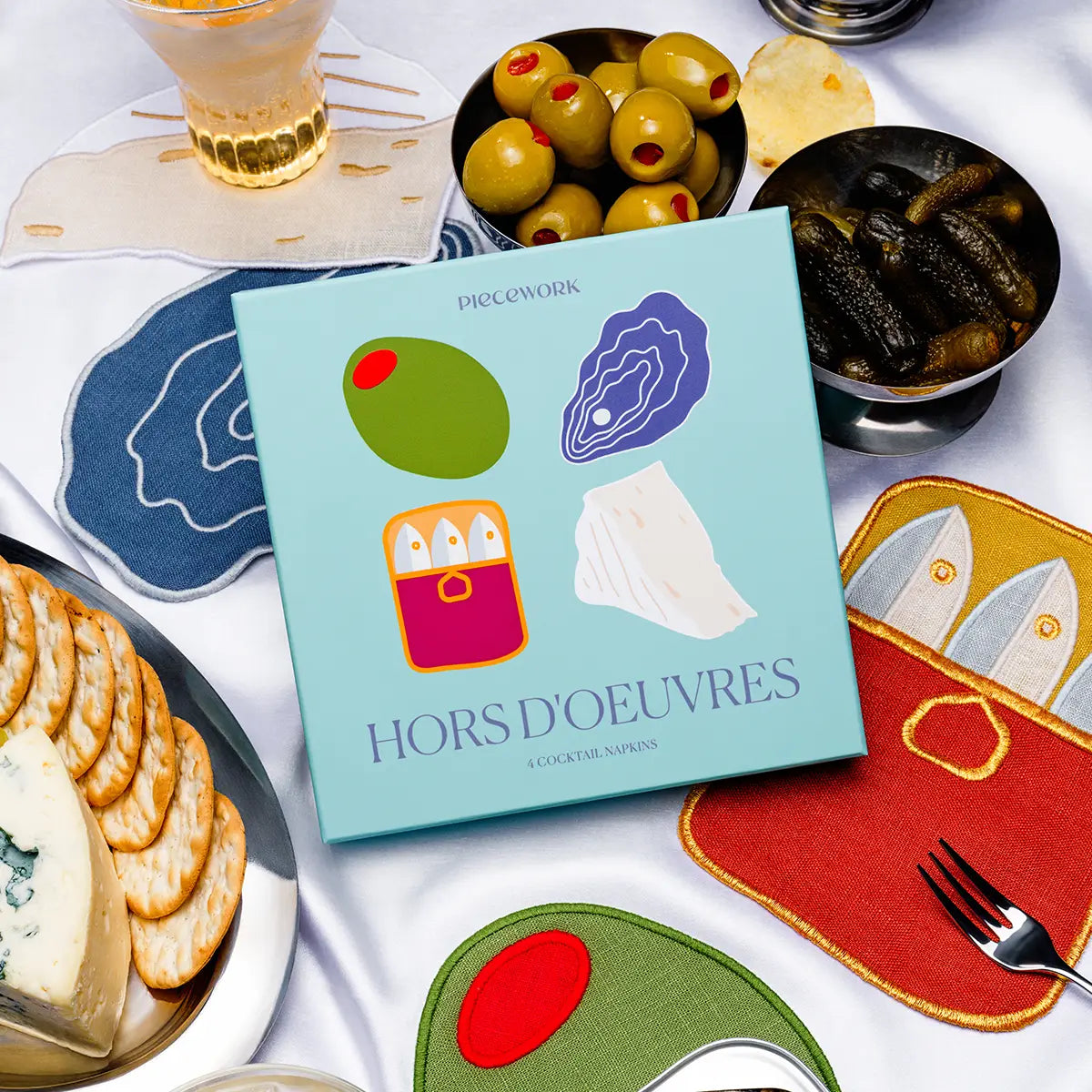 Coasters with food illustrations and a packaging box titled &