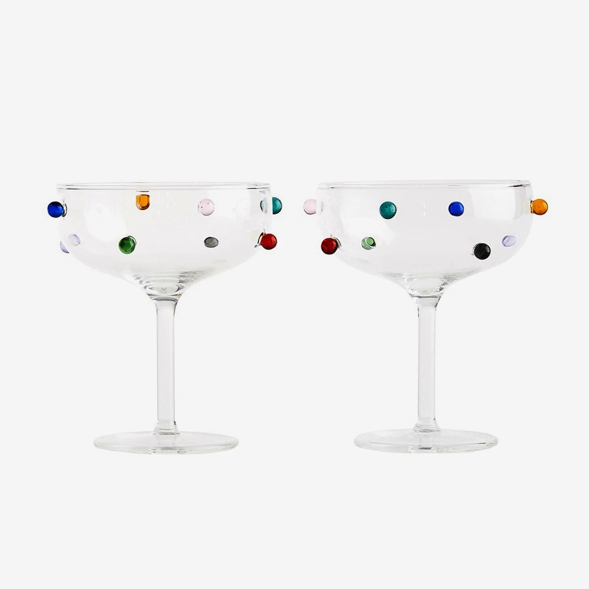 Two cocktail coupe glasses with colorful dot patterns by Maison Balzac