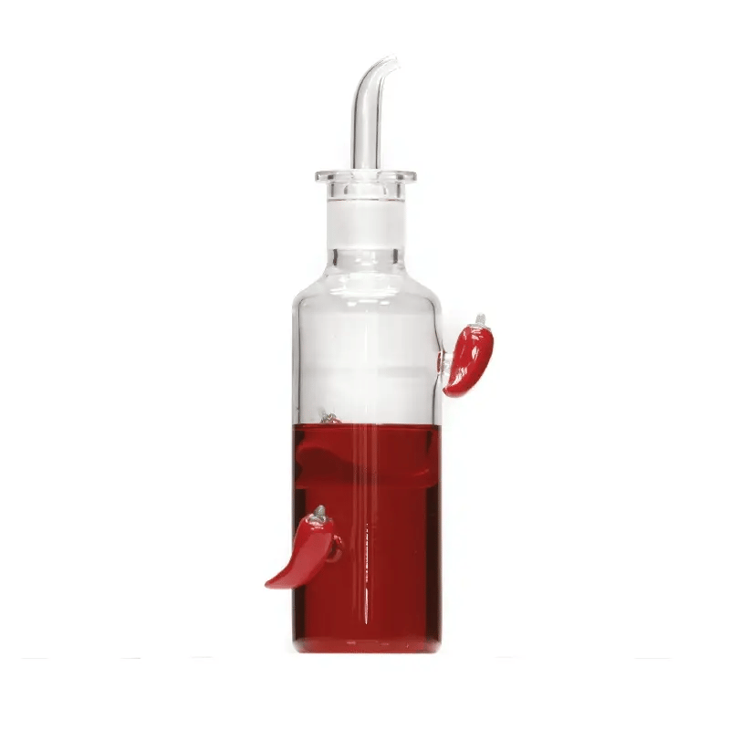 Clear glass bottle with red liquid and chili pepper design on a white background