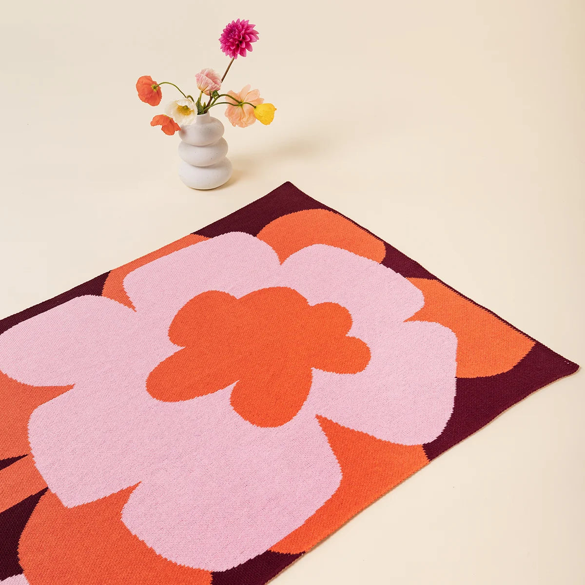 Petal pop Mini Knit Blanket by Slowdown Studio designed in collaboration with artist Micke Lindebergh
