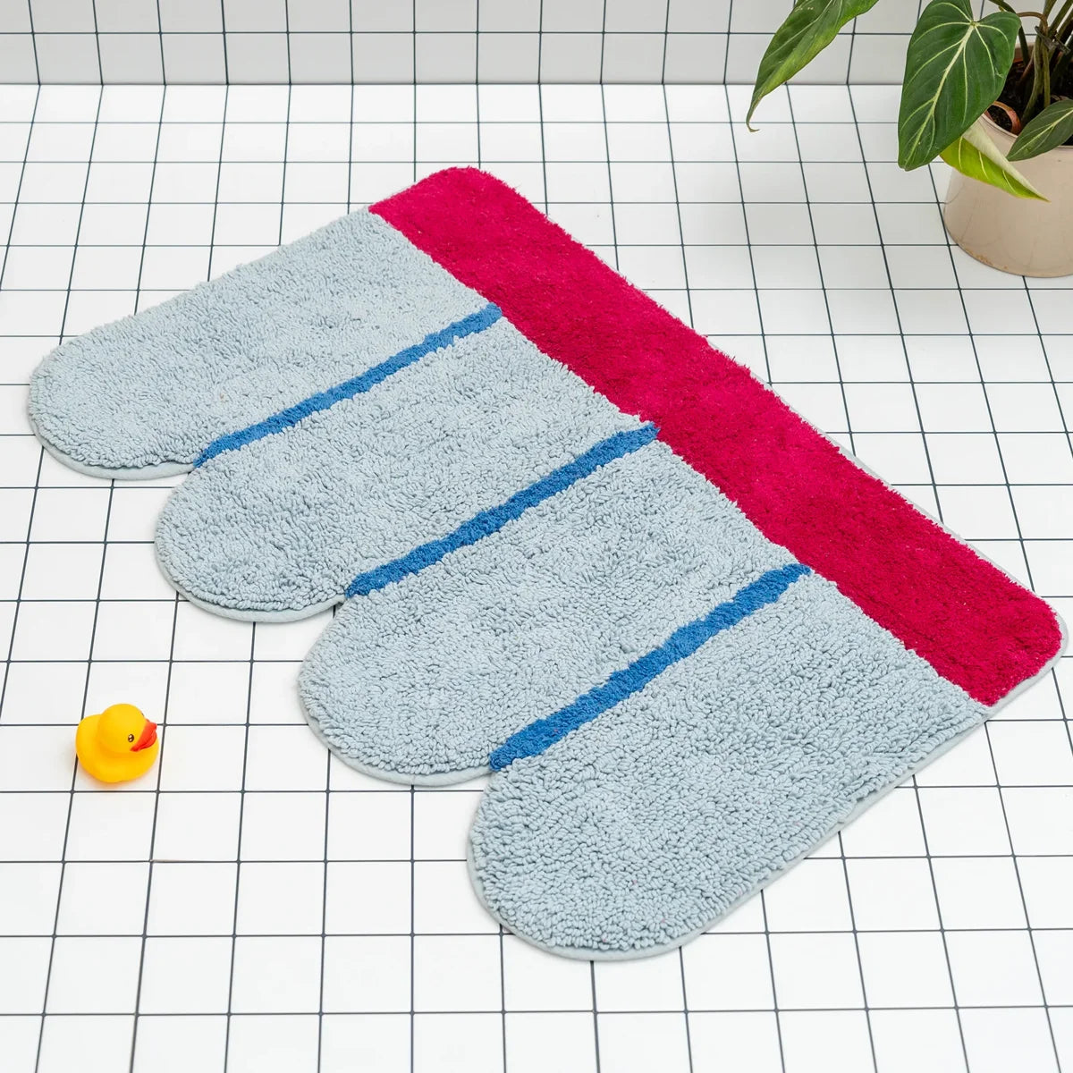 Designer bath mat with blue and pink design, designed in Barcelona