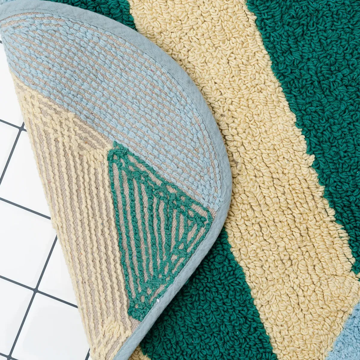 Close-up of a textured rug with geometric pattern on a white background