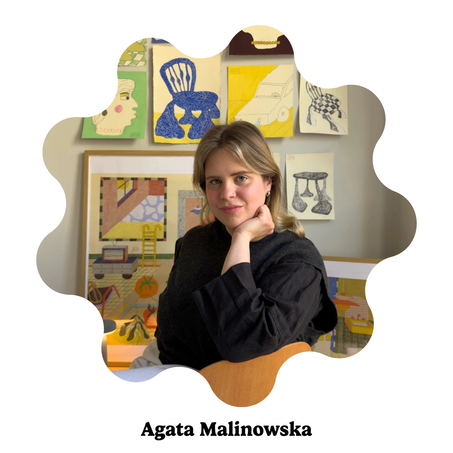 A portrait of the Polish female artist Agata Malinowska, posed in front of a wall decorated with colorful wall art.