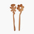 Two light natural wood flower-shaped Serving Friends spoons from Areaware, photographed against a solid off-white background.