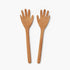 Two wooden salad servers shaped like hands on a white background