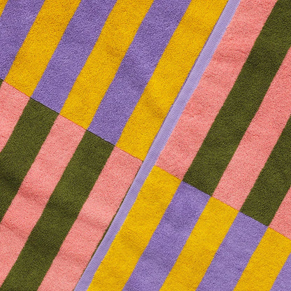 Colorful striped towel with pink, yellow, green, and purple stripes.
