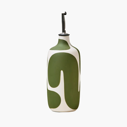 Green and white ceramic oil bottle on a white background