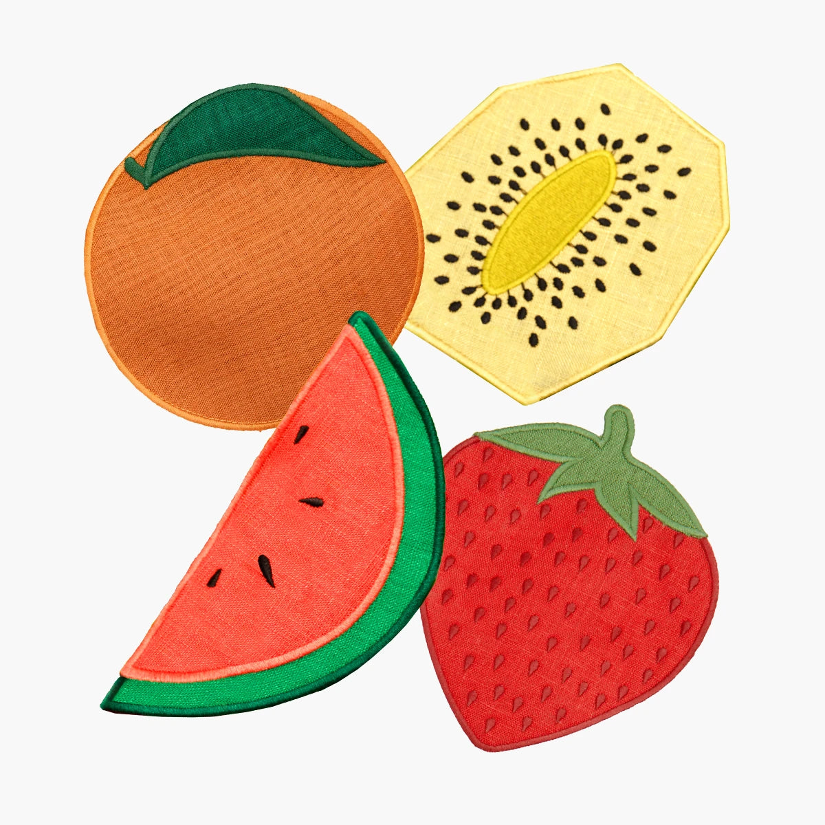Set of colorful fruit-shaped coasters on a white background