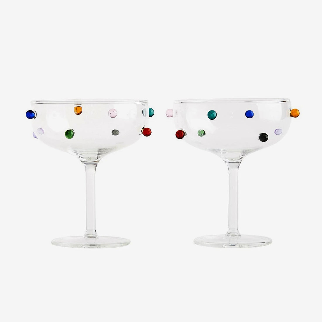 Two cocktail coupe glasses with colorful dot patterns by Maison Balzac