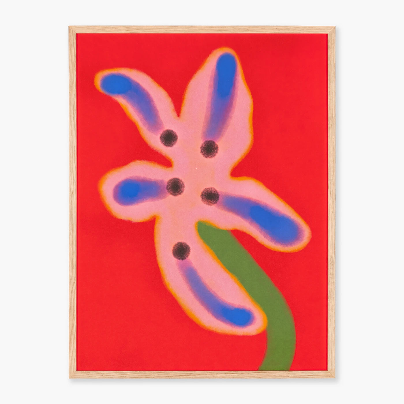 Framed abstract floral wall art featuring a pink flower with blue and green accents on a bright red background, enclosed in a light natural wood frame.