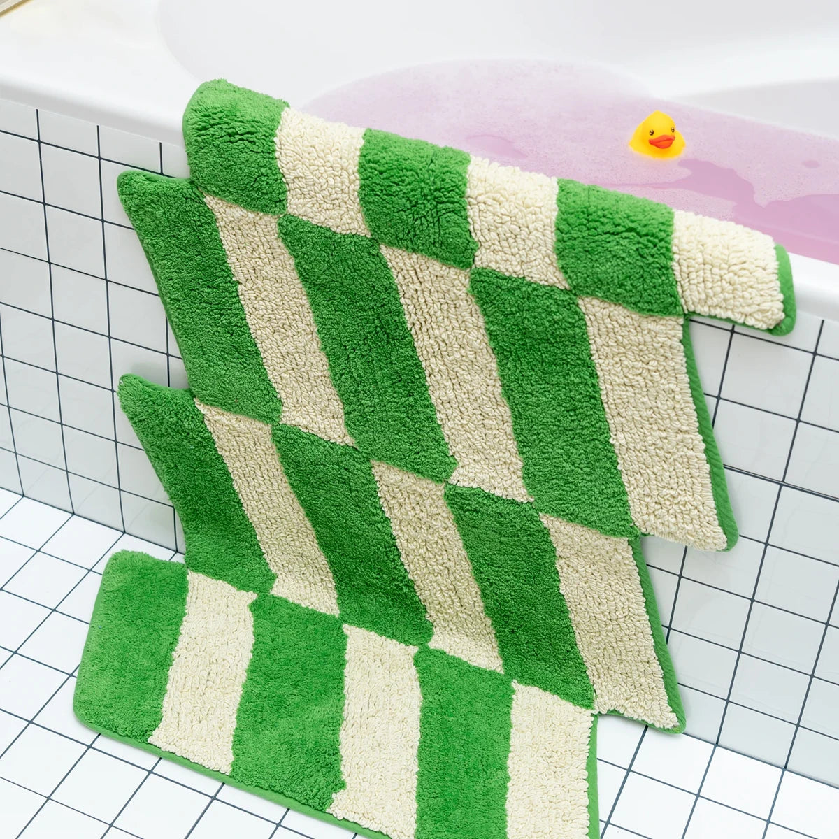 Green and white checkered bath mat on a grid background